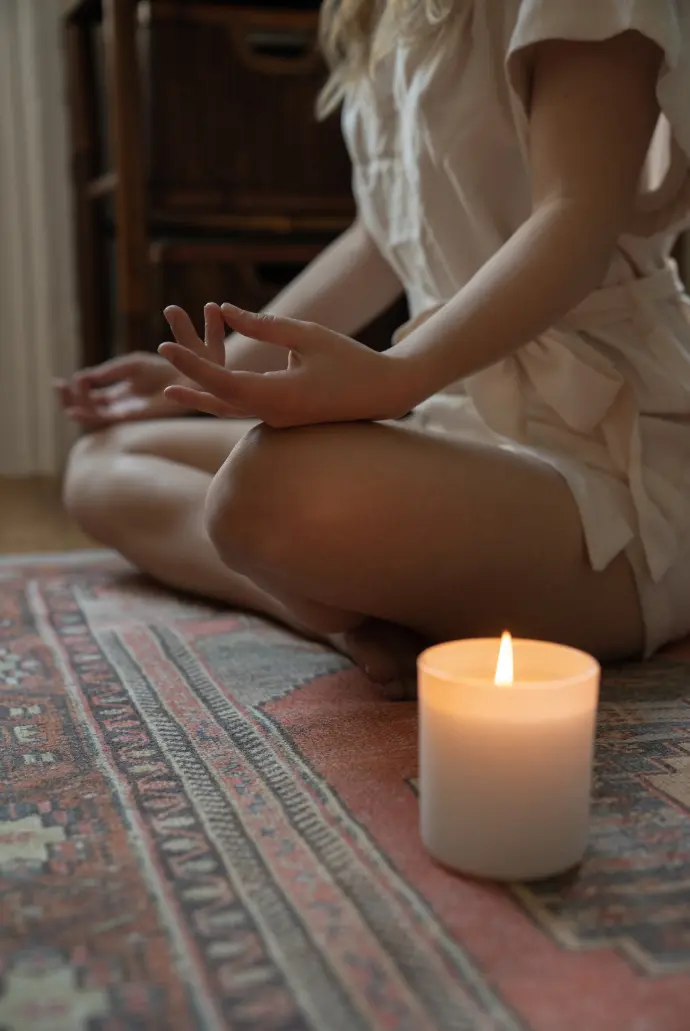 Erika Bordon Etre Essentiel en méditation avec une bougie blanche allumée